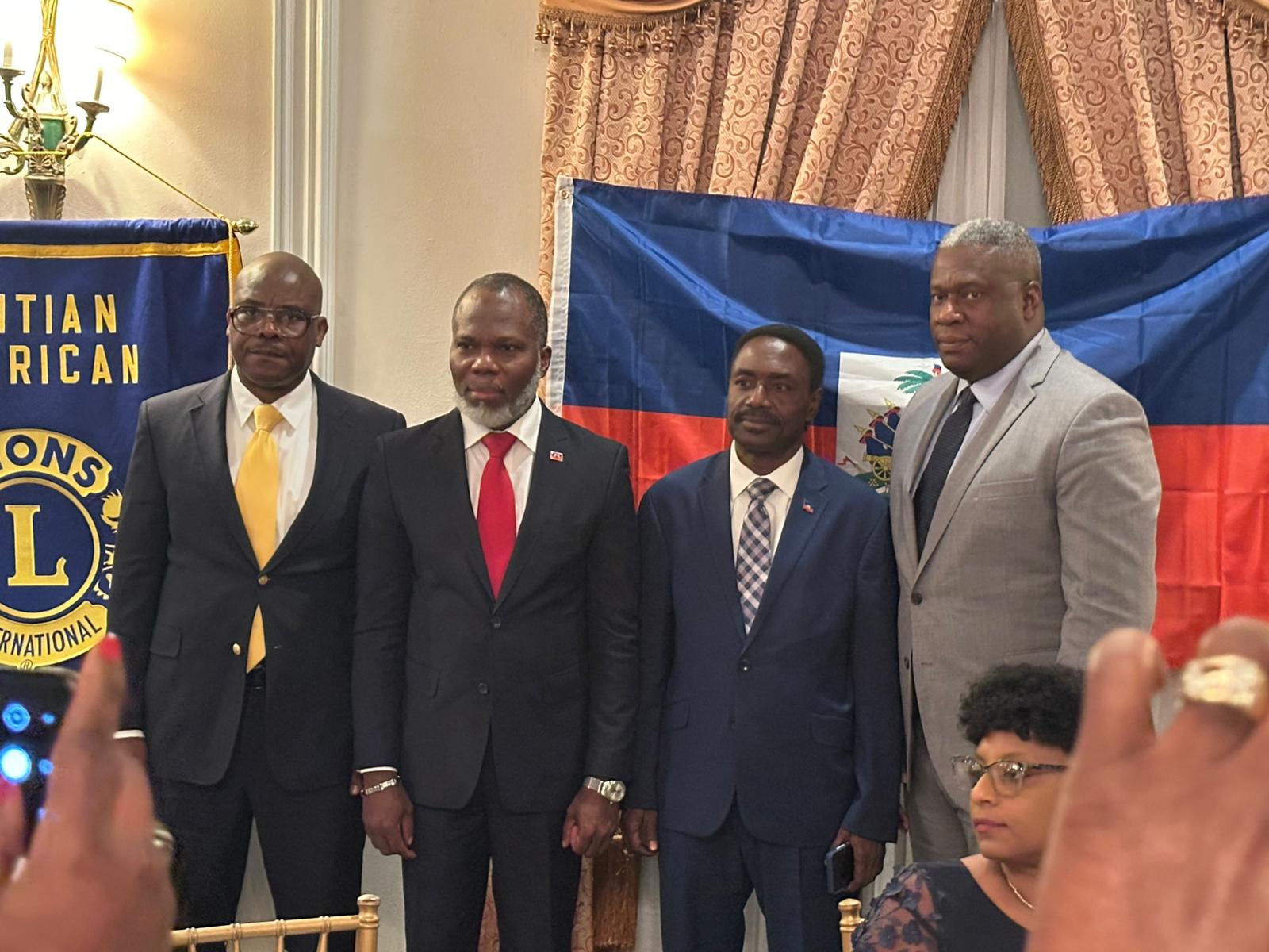 Officers gathered before the Haitian flag