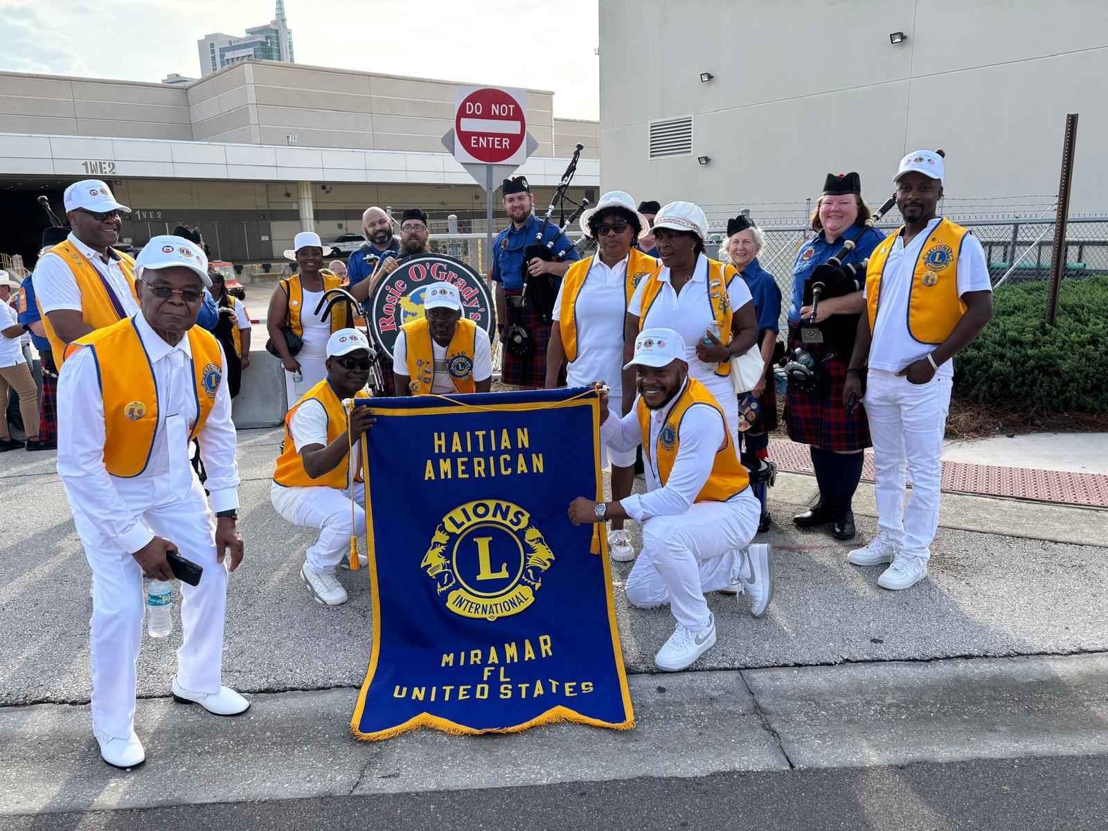 Members marching with the club banner